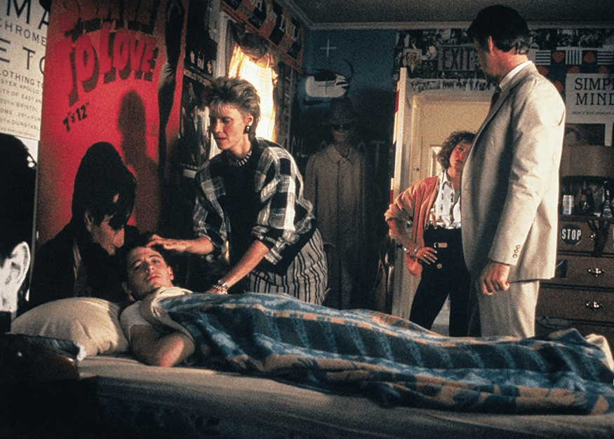 (L–R) Ferris Bueller (Matthew Broderick), Mrs. Bueller (Cindy Pickett), Jeanie Bueller (Jennifer Grey), and Mr. Bueller (Lyman Ward). Ferris's parents are concerned that he is quite sick, in "Ferris Bueller's Day Off." (Paramount Pictures)