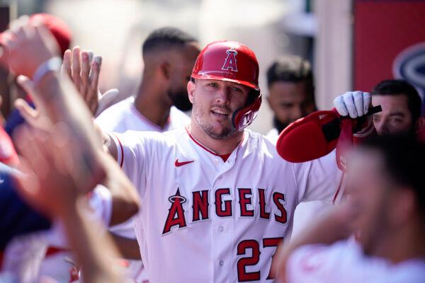 Los Angeles Angels' Mike Trout (27) celebrates in the dugout after scoring off of a single hit by Taylor Ward during the first inning of a baseball game against the Texas Rangers in Anaheim, Calif., on Oct. 2, 2022. (Ashley Landis/AP Photo)
