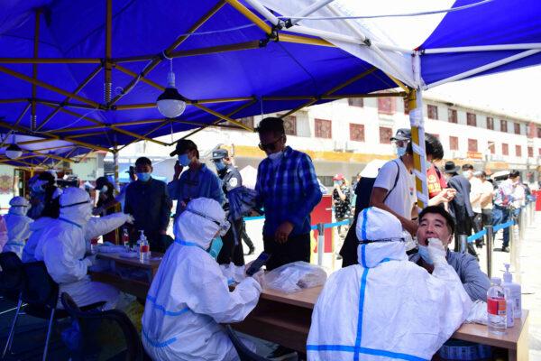 People getting swabbed for nucleic acid testing for the COVID-19 coronavirus in Lhasa, Tibet on Aug. 9, 2022. (-/CNS/AFP via Getty Images)