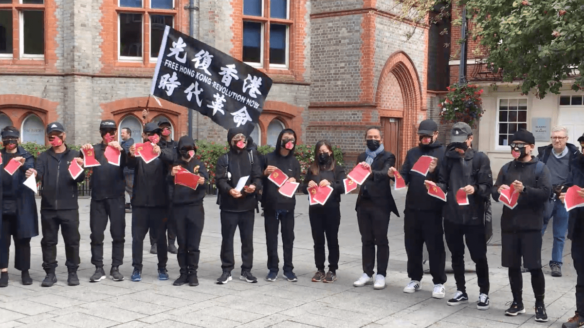 Participants tore up the CCP flags at the rally in Reading, on Oct 1, 2022. (Shan Lam/The Epoch Times)