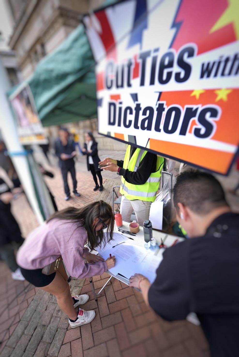 A young woman signed the petition calling on the British city governments to sever their ties with sister cities in China, in Birmingham on Oct. 1, 2022. (Courtesy of Good Neighbour Church England)