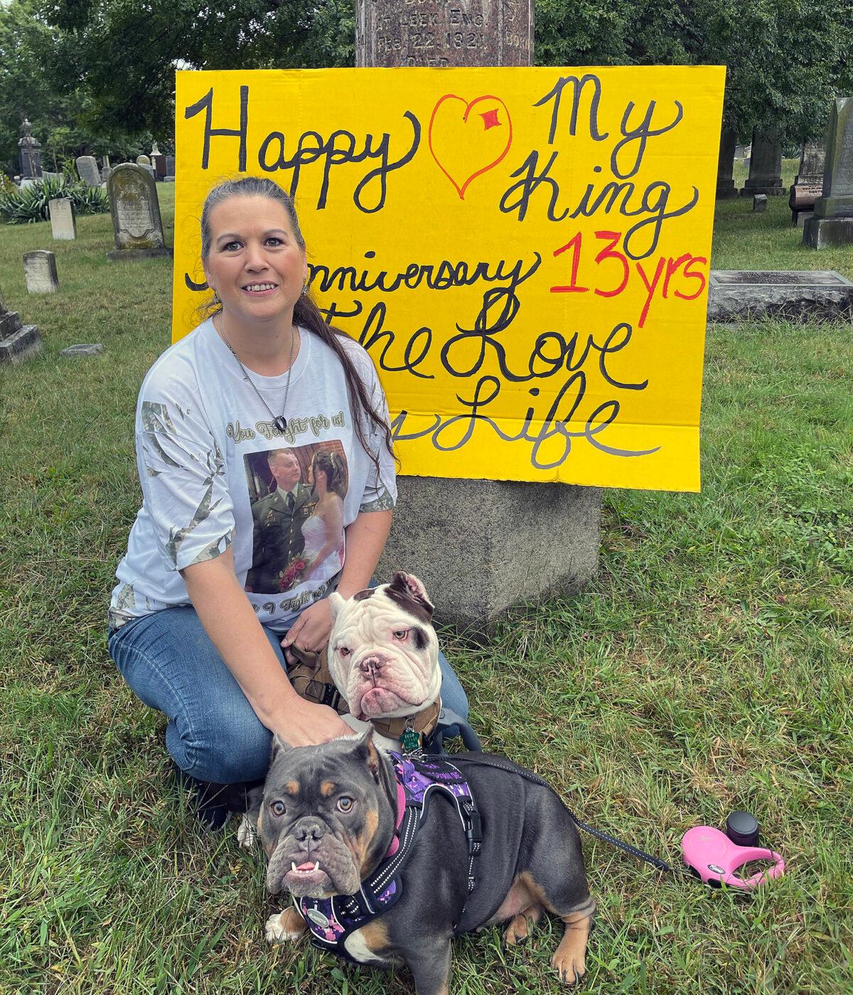 Angel Harrelson with her dogs Kyra and Thor, outside the D.C. jail, where she held up an anniversary message for her husband, Ken, on Oct. 1, 2022. (Brad Geyer/Special to The Epoch Times)