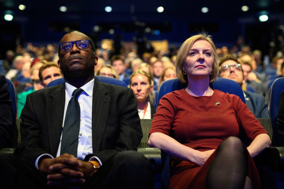 Chancellor of the Exchequer Kwasi Kwarteng (L) and Britain's Prime Minister Liz Truss watch a tribute to Queen Elizabeth II on the opening day of the annual Conservative Party conference in Birmingham, England, on Oct. 2, 2022. (Leon Neal/Getty Images)