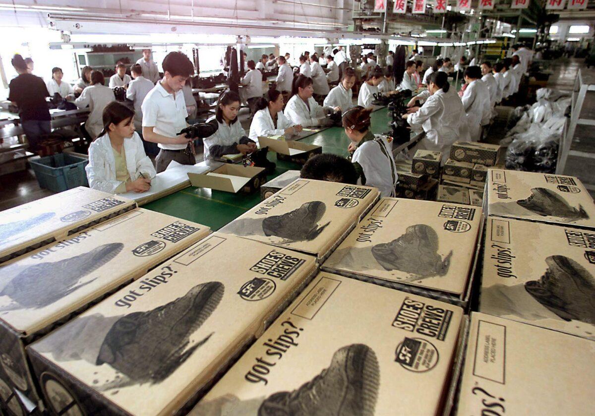 Workers produce shoes for a U.S. company at a state-owned factory in Shenyang, China, on May 31, 2000. (Goh Chai Hin/AFP via Getty Images)