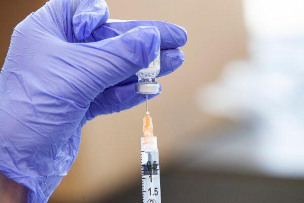 A COVID-19 vaccine is prepared in a file image. (Stephen Zenner/Getty Images)