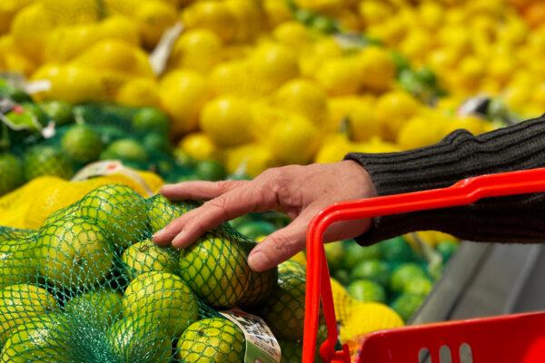 A customer selects limes at a fruit stand in the central business district in Sydney, Australia, on Aug. 16, 2022. (Lisa Maree Williams/Getty Images)