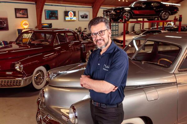 Senior director of the Tucker Automobile Club of America and five-time Tucker 48 owner Mark Lieberman, with two Tuckers at his Michigan-based car dealership, Nostalgic Motoring. ( Courtesy of Mark Lieberman)