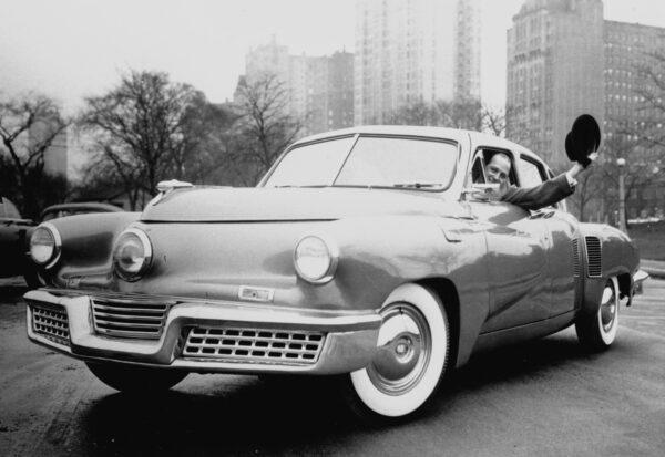 Automotive visionary Preston Tucker drives one of the cars he designed. (Courtesy of the AACA Museum)