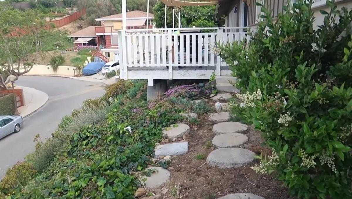 Steps leading to the Koutroumbis's front porch, with their hill garden to the left. (Courtesy of <a href="https://www.instagram.com/mykidsaredirtyagain/">Taylor Raine</a>)