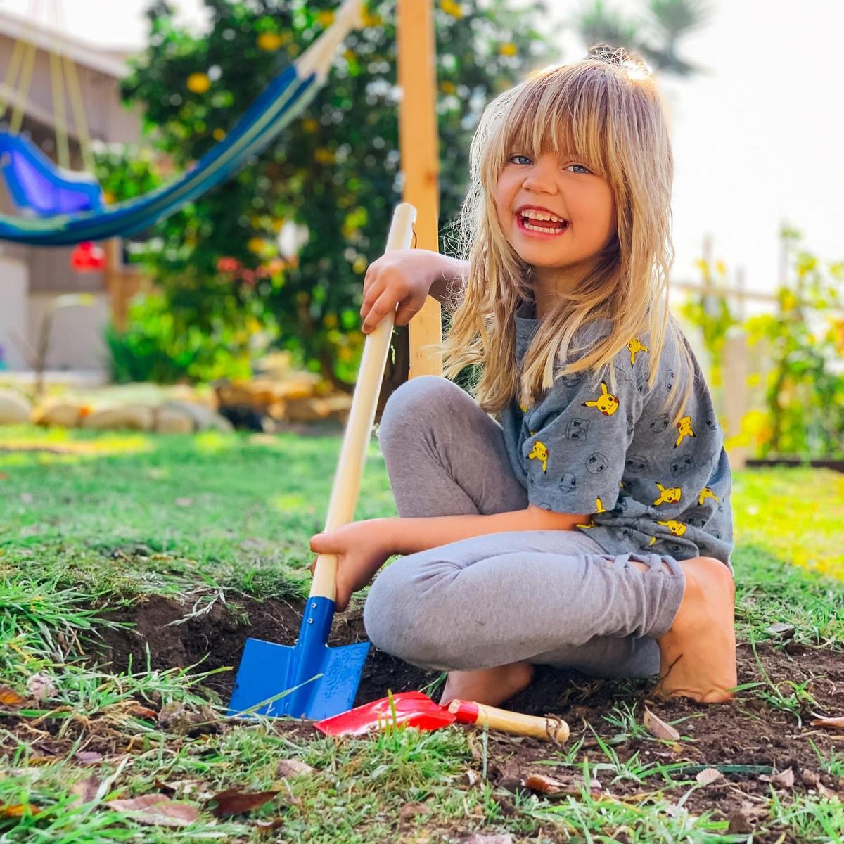 Evelyn helping in the garden. (Courtesy of <a href="https://www.instagram.com/mykidsaredirtyagain/">Taylor Raine</a>)