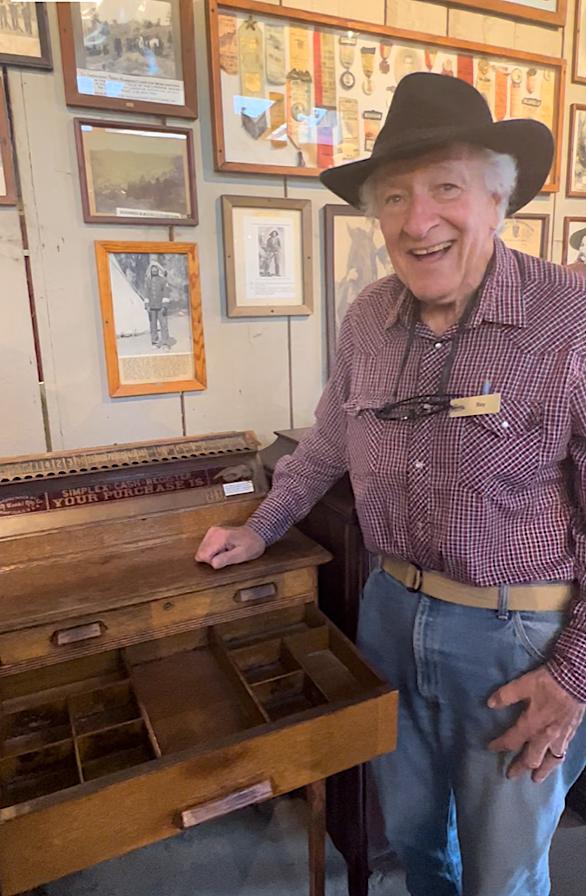 A staff member explains how clerks used marbles to balance their Simplex cash register. (Courtesy of Karen Gough)