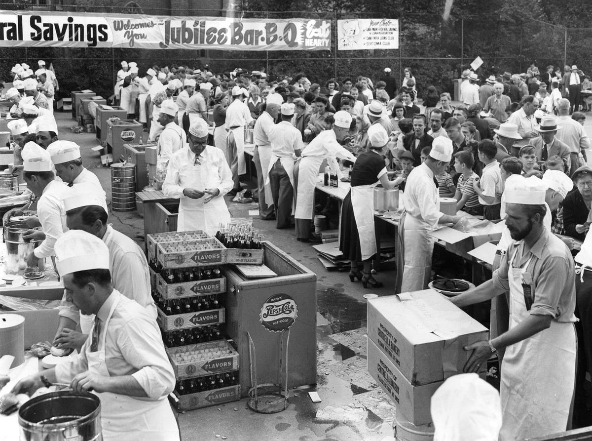 Oak Parkers celebrate the village's golden jubilee by downing a half-ton of barbecued meat, 7,200 buns and and uncounted bottles of pop in less than an hour in 1951. (Chicago Tribune/TNS)