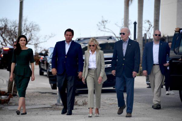 Casey DeSantis (L), Florida Governor Ron DeSantis (2L), US First Lady Jill Biden (C), and US President Joe Biden (R) walk to meet with local residents impacted by Hurricane Ian at Fishermans Pass in Fort Myers, Fla., on Oct. 5, 2022. (Olivier Douliery/AFP via Getty Images)