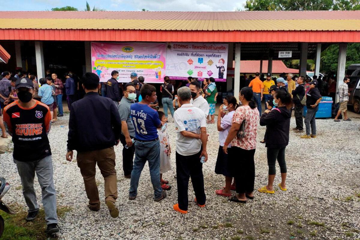 People gather outside of a day care center's scene of rampage in the town of Uthai Sawan, 500 kilometers (310 miles) northeast of Bangkok in the Province of Nong Bua Lamphu, Thailand, on Oct. 6, 2022. (Sakdipat Boonsom/Handout via Reuters)
