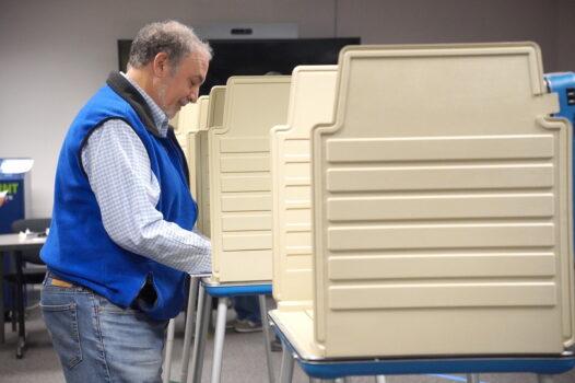 A man casts his vote during the early voting period for the midterms at the Fairfax County Government Center in Fairfax, Va., on Oct. 7, 2022. (Terri Wu/The Epoch Times)