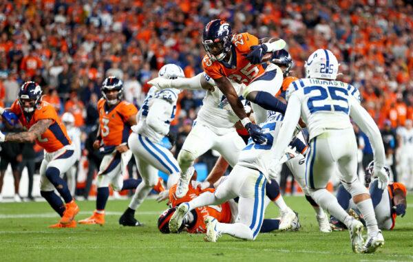 Melvin Gordon III (25) of the Denver Broncos rushes in overtime during a game against the Indianapolis Colts at Empower Field At Mile High in Denver, on Oct. 6, 2022. (Justin Tafoya/Getty Images)