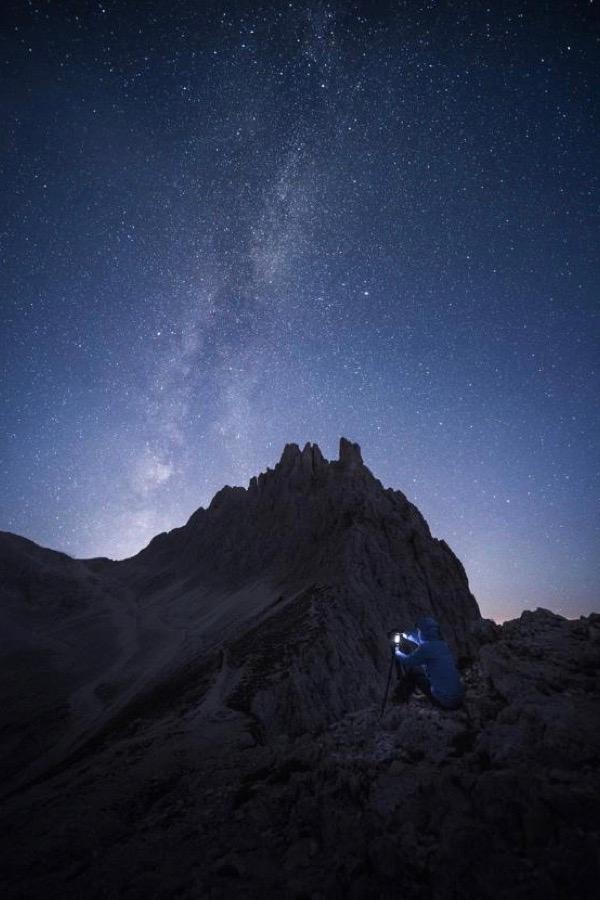 Kelvin Yuen photographing the night sky with a mountain backdrop.  (Courtesy of Kelvin Yuen)