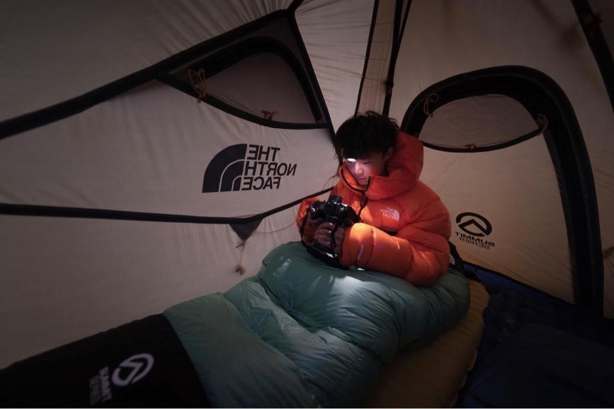 Kelvin Yuen checks the images on his camera in a tent during his wilderness shoot. (Courtesy of Kelvin Yuen)