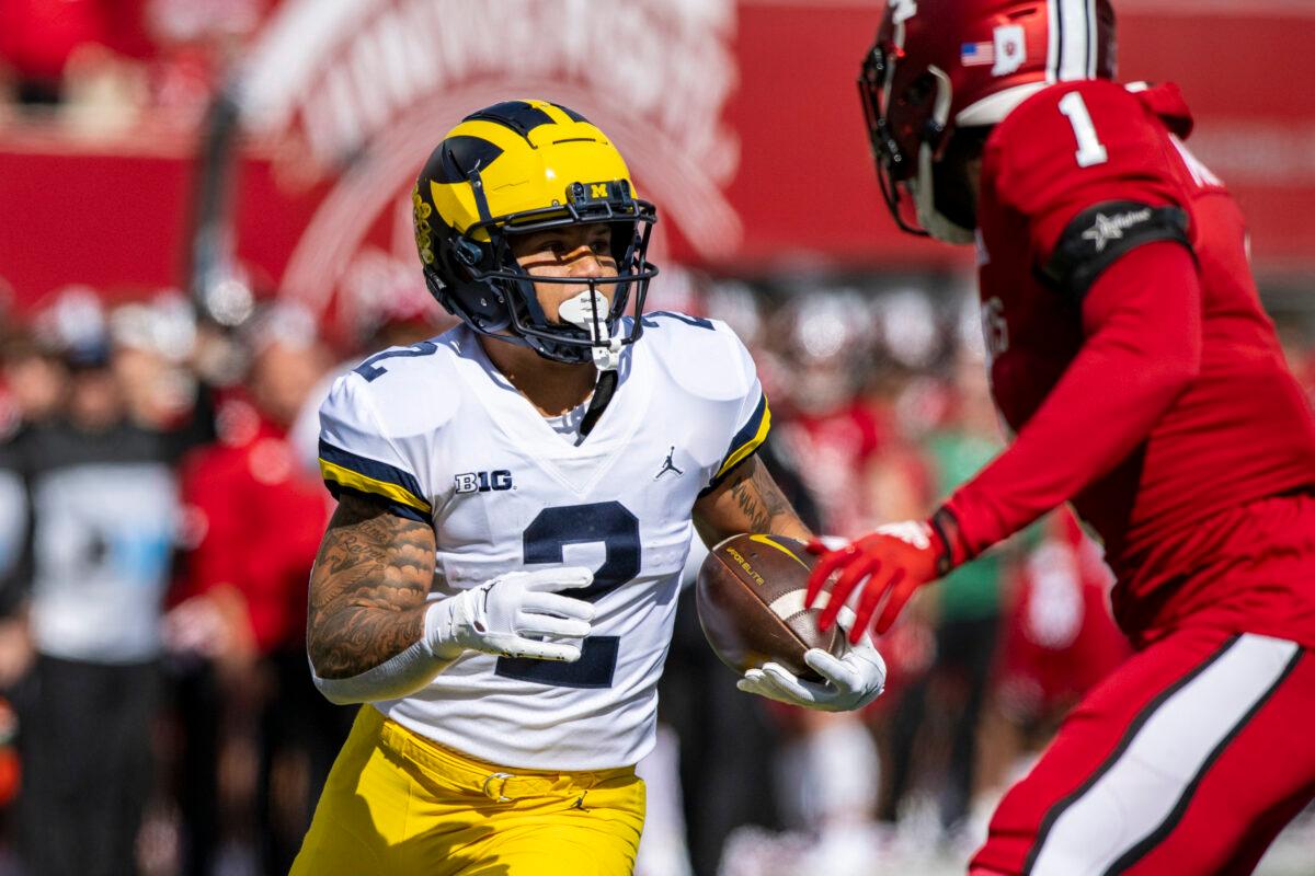 Michigan running back Blake Corum (2) runs the ball into the Indiana defense during the first half of an NCAA college football game, in Bloomington, Ind., on Oct. 8, 2022. (Doug McSchooler/AP Photo)