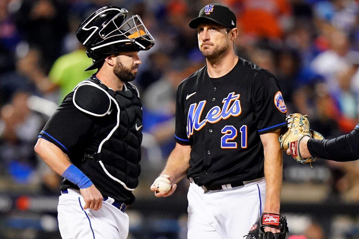 New York Mets starting pitcher Max Scherzer (21) waits on the mound with catcher Tomas Nido during a pitching change during the fifth inning of Game 1 of a National League wild-card baseball playoff series against the San Diego Padres in New York on Oct. 7, 2022. (Frank Franklin II/AP Photo)