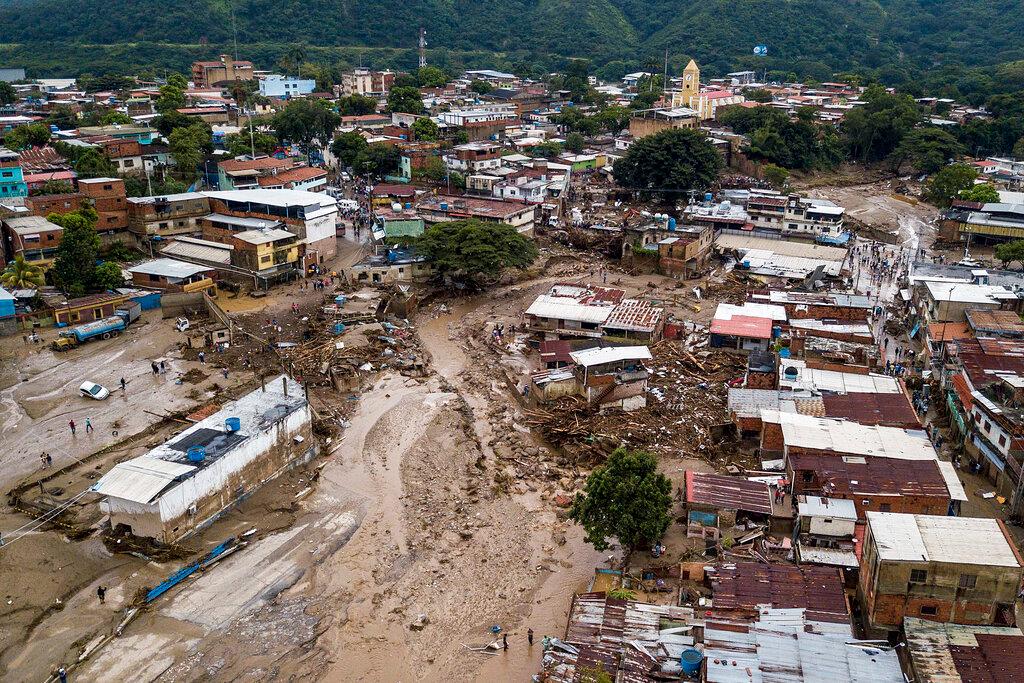 Streets are flooded after heavy rains caused a river to overflow in Las Tejerias, Venezuela, on Oct. 9, 2022. (Matias Delacroix/AP Photo)
