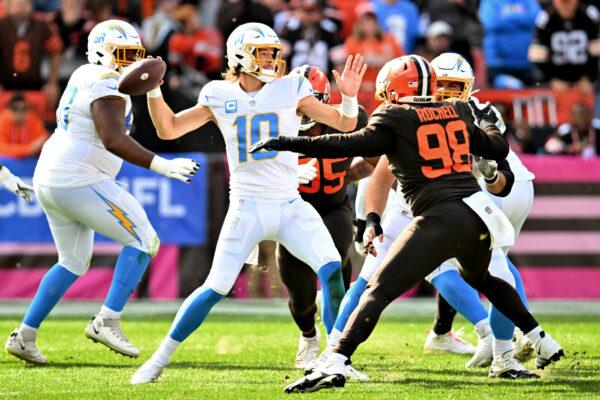 Justin Herbert (10) of the Los Angeles Chargers attempts a pass during the fourth quarter against the Cleveland Browns at FirstEnergy Stadium in Cleveland, on Oct. 9, 2022. (Jason Miller/Getty Images)