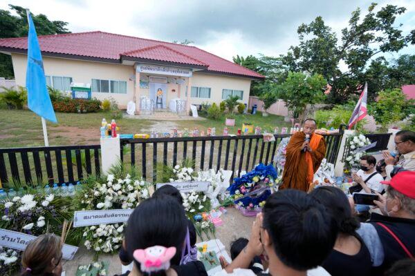 Relatives of the victims of a mass killing attack gather for a Buddhist ceremony in front of the Young Children's Development Center in the rural town of Uthai Sawan, north eastern Thailand, on Oct. 9, 2022. (Sakchai Lalit/AP Photo)