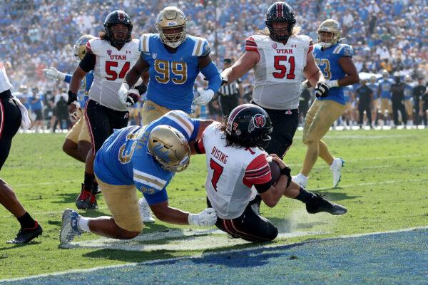 Jay Toia (93) of the UCLA Bruins is unable to stop Cameron Rising (7) of the Utah Utes as he scores a rushing touchdown during the second half of a game at the Rose Bowl in Pasadena, Calif., on Oct. 8, 2022. (Sean M. Haffey/Getty Images)