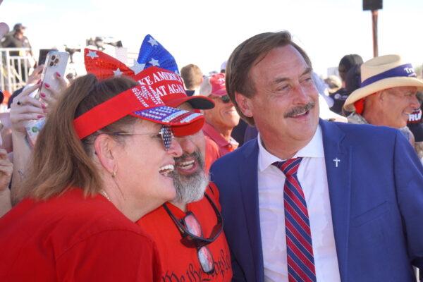 MyPillow CEO Mike Lindell (R) poses with an America First supporter during a rally in Mesa, Ariz., on Oct. 9. (Allan Stein/The Epoch Times)