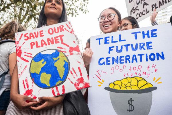 Two school students holding placards as they march in Melbourne, Australia, on Sept. 20, 2019. (Asanka Ratnayake/Getty Images)