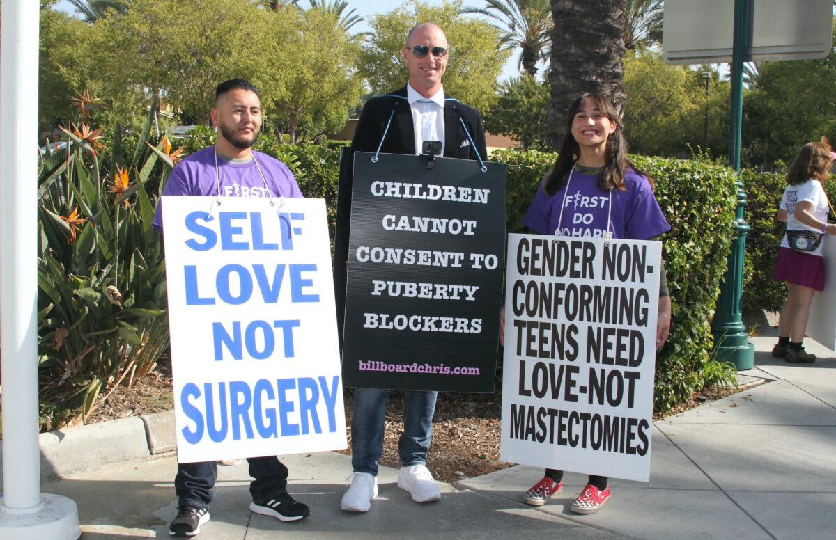 (L-R) Detransitioner Abel Garcia, activist Billboard Chris, and detransitioner Chloe Cole take part in a demonstration in Anaheim, Calif., on Oct. 8, 2022. (Brad Jones/The Epoch Times)