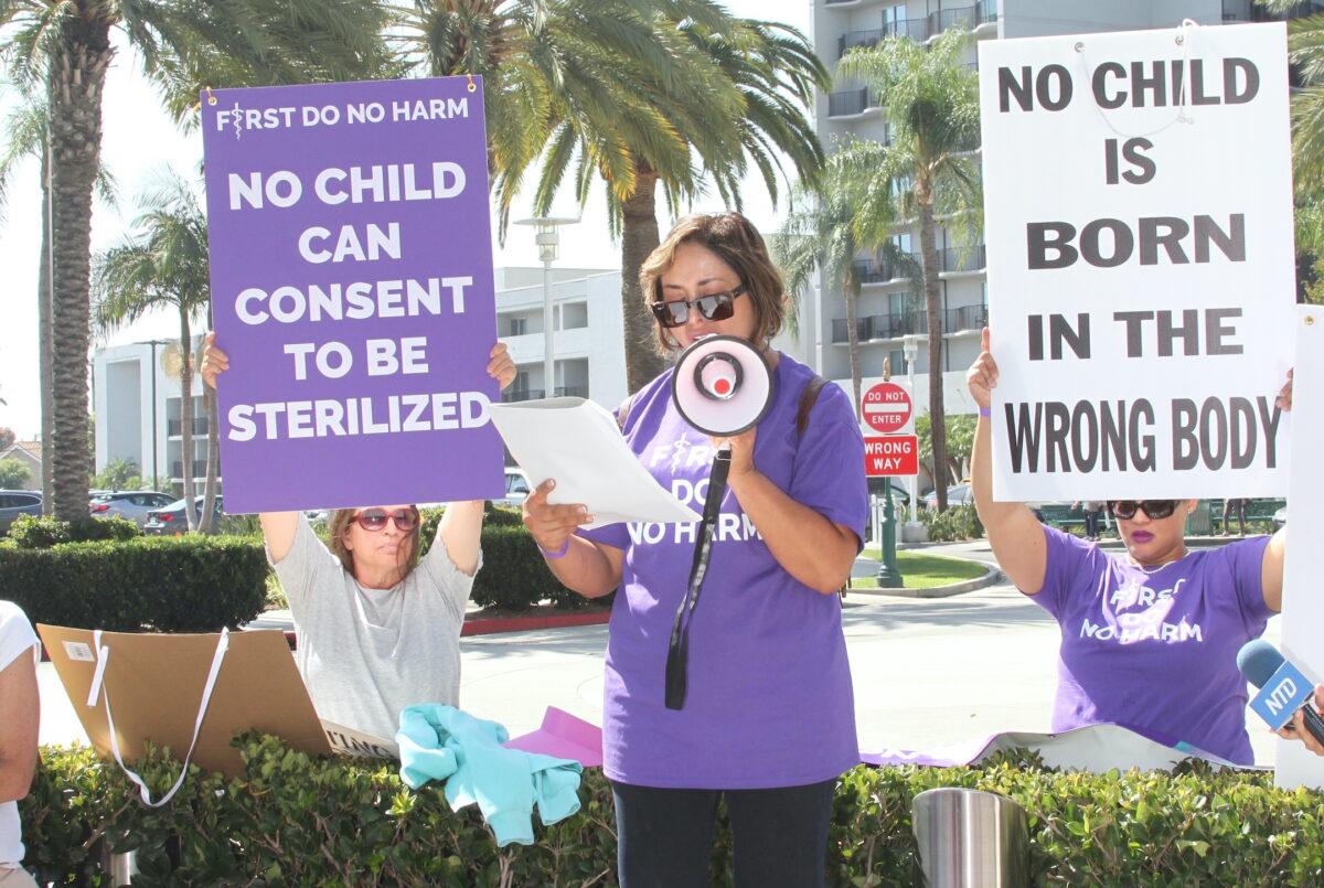 A mother takes part in a demonstration in Anaheim, Calif., on Oct. 8, 2022. (Brad Jones/The Epoch Times)
