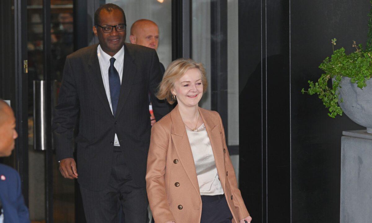 Chancellor of the Exchequer Kwasi Kwarteng (L) and Prime Minister Liz Truss leave their hotel ahead of a local visit in Birmingham, England, on Oct. 4, 2022. (Leon Neal/Getty Images)