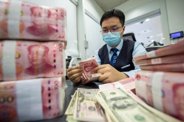 A staff member counts renminbi (yuan) at a bank in Haian, Nantong city, East China's Jiangsu Province, on May 15, 2022. (CFOTO/Future Publishing via Getty Images)