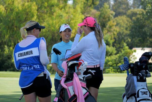 Danielle Kang (C), native of nearby Westlake Village, Calif. shares laughs with Paula Creamer (R) and her caddie (L) following opening round of the LPGA MEDIHEAL Championship at The Saticoy Club in Somis, Calif., on Oct. 6, 2022. (Nhat Hoang/The Epoch Times)