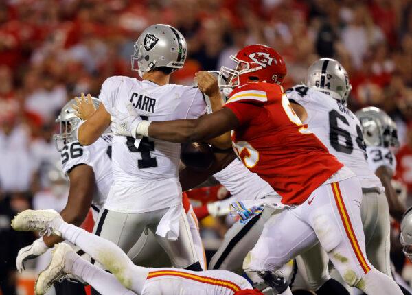 Derek Carr (4) of the Las Vegas Raiders is sacked by Chris Jones (95) of the Kansas City Chiefs during the 2nd quarter of the game at Arrowhead Stadium in Kansas City, on Oct. 10, 2022. (David Eulitt/Getty Images)