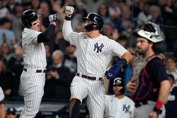 New York Yankees Anthony Rizzo, left, celebrates with Aaron Judge after hitting a two-run home run against the Cleveland Guardians during the sixth inning of Game 1 of an American League Division baseball series, in New York, on Oct. 11, 2022. (John Minchillo/AP Photo)