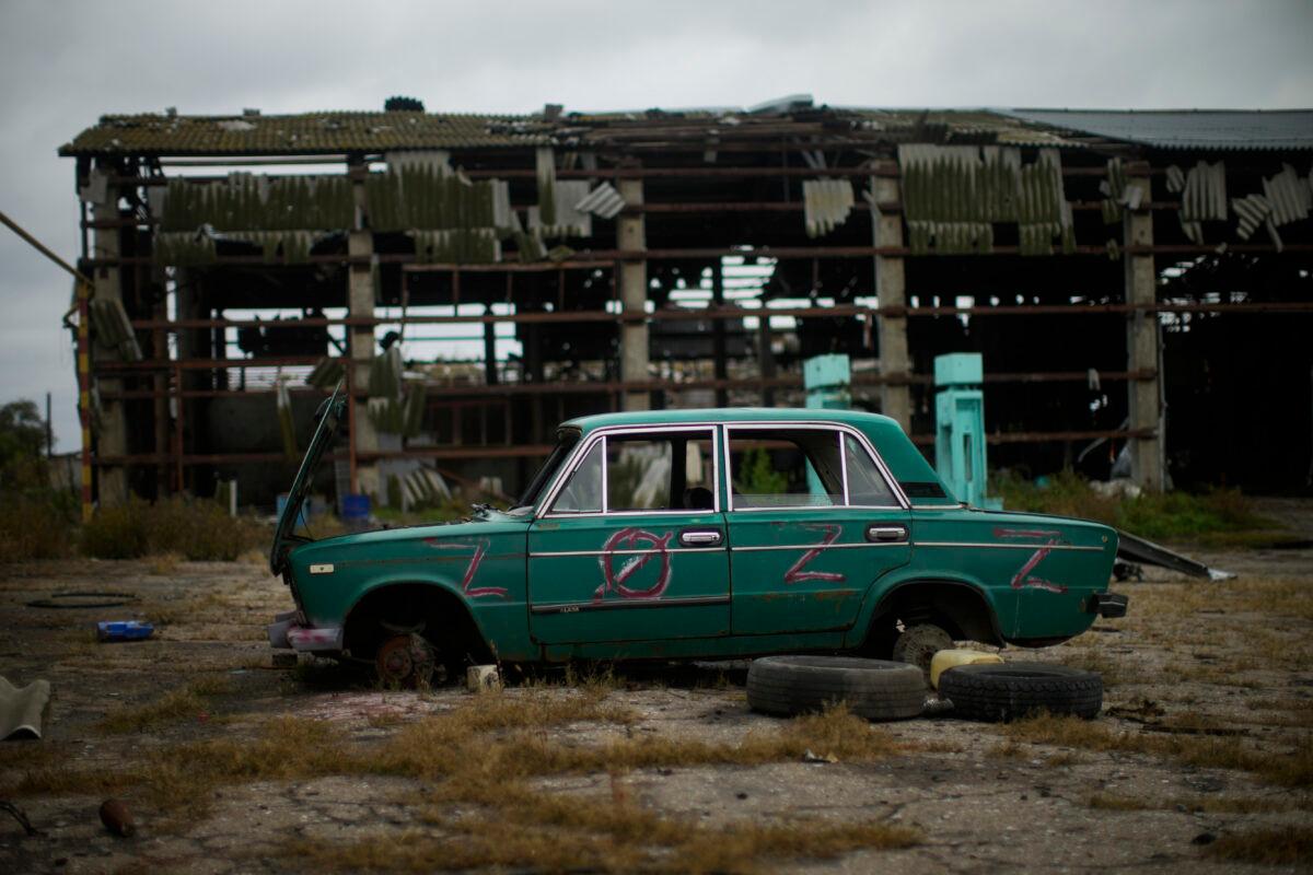 An abandoned car lies on the ground in a heavily damaged grain factory where Russians forces gathered destroyed vehicles at the recaptured town of Lyman, Ukraine, on Oct. 11, 2022. (Francisco Seco/AP Photo)