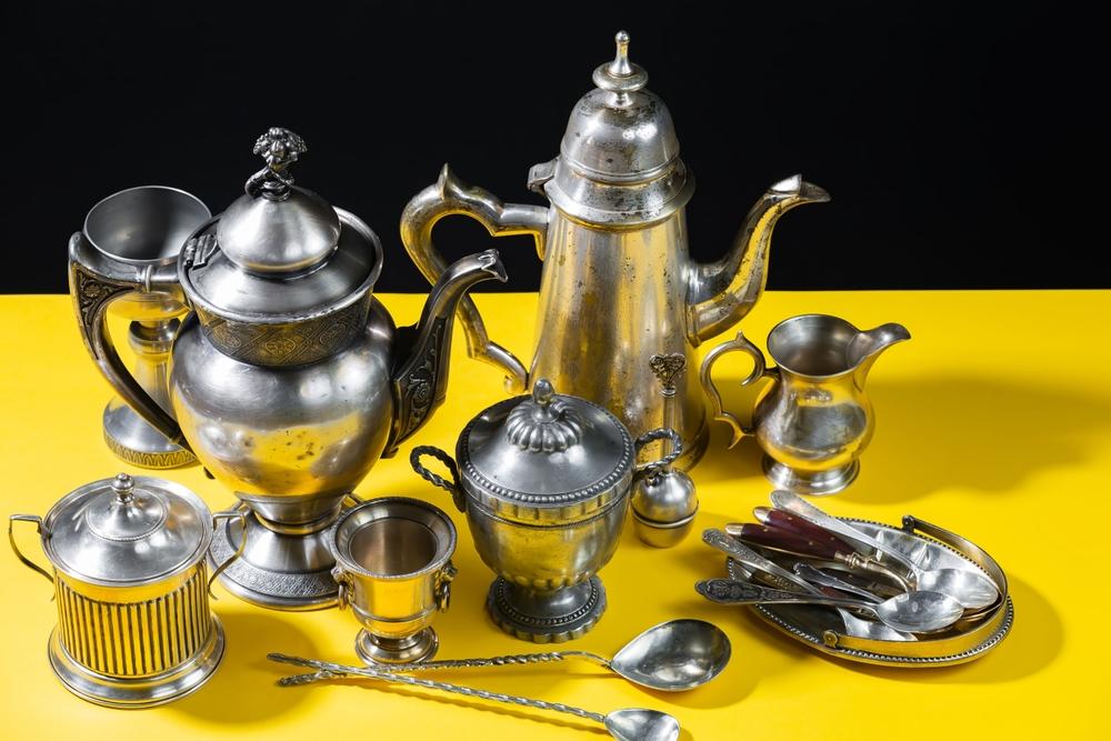 If you’ve got a silver service, soak them in a bowl lined with aluminum foil and filled with hot water and a tablespoon of laundry detergent. (Zadorozhnyi Viktor/Shutterstock)