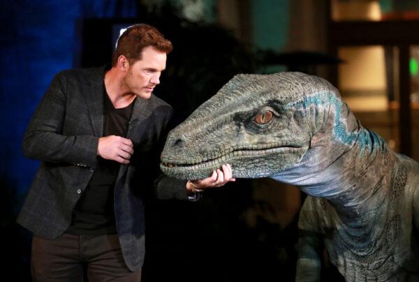 Chris Pratt and Blue the velociraptor interact onstage at the grand opening celebration of "Jurassic World—The Ride" at Universal Studios Hollywood in Universal City, California, on July 22, 2019. (Rich Fury/Getty Images for Universal Studios Hollywood)
