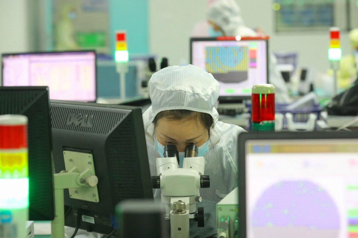 An employee makes chips at a Jiejie Semiconductor Company factory in Nantong, in eastern China's Jiangsu province, on March 17, 2021. (STR/AFP via Getty Images)