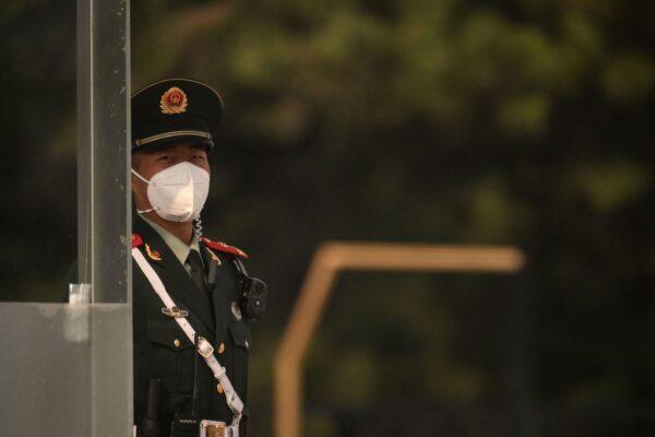 A member of security stands guard ahead of China’s 20th Communist Party Congress in Beijing on Oct. 13, 2022. (Noel Celis/AFP via Getty Images)