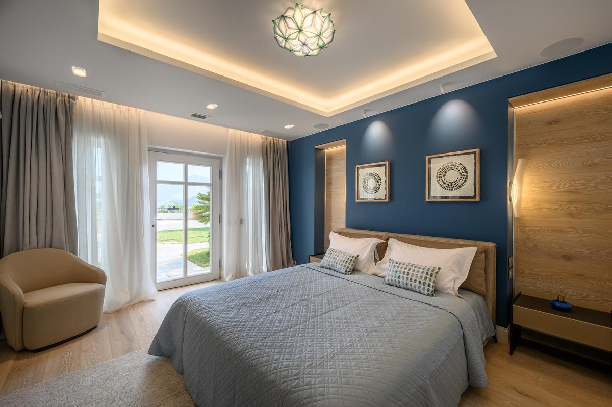 All of the bedrooms are well-appointed and inviting, with those on the lower level offering easy access to the gardens, terraces, and pool. (Courtesy of Greece Sotheby's International Realty)