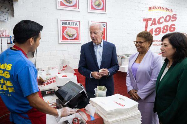 US President Joe Biden makes a surprise visit to pick up lunch alongside US Representative Karen Bass (C), Democrat of California, and Los Angeles County Supervisor Hilda Solis (R) at Tacos 1986 in Los Angeles, Calif., on Oct. 13, 2022. (Saul Loeb/AFP via Getty Images)