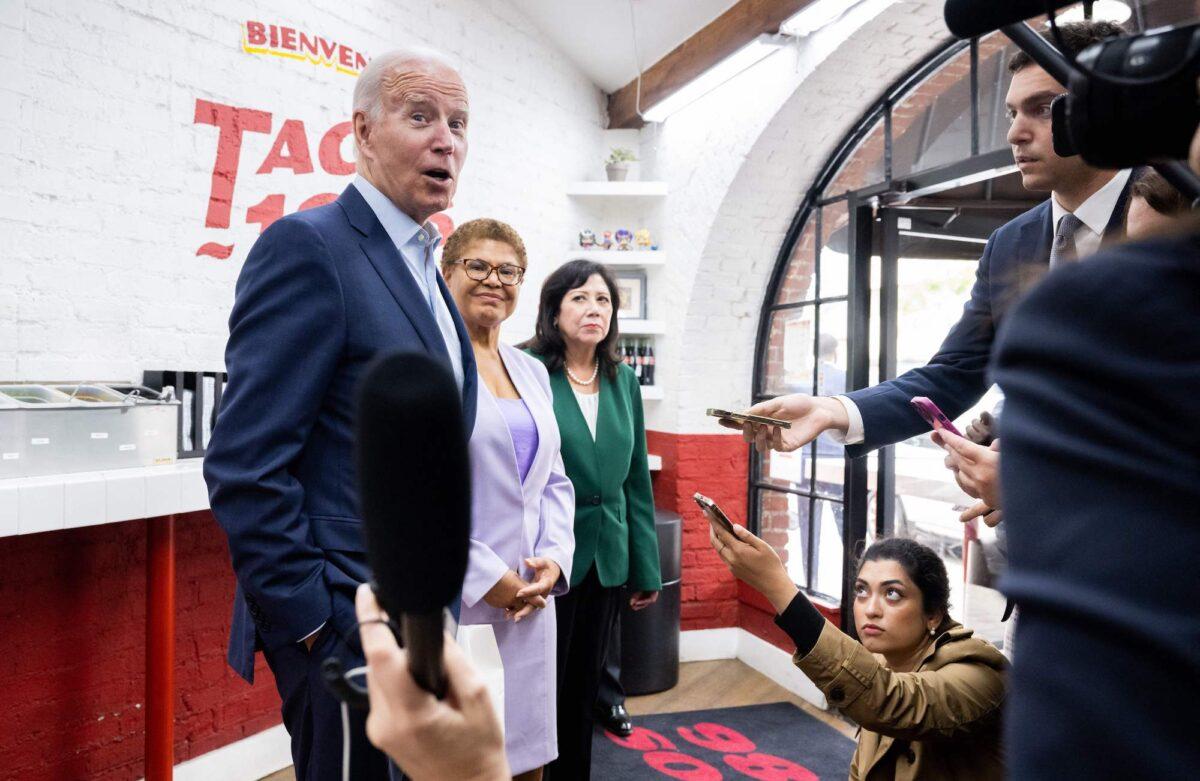 U.S. President Joe Biden speaks to the press as he makes a surprise visit to pick up lunch alongside U.S. Rep. Karen Bass (D-Calif.) (C) and Los Angeles County Supervisor Hilda Solis (R) at Tacos 1986 in Los Angeles, California, on Oct. 13, 2022. (Saul Loeb/AFP via Getty Images)