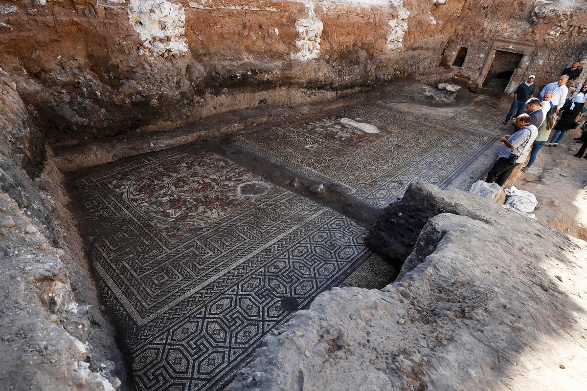 Onlookers gaze at a large mosaic that dates back to the Roman era in the town of Rastan, Syria, Wednesday, Oct. 12, 2022. (Omar Sanadiki/AP Photo)