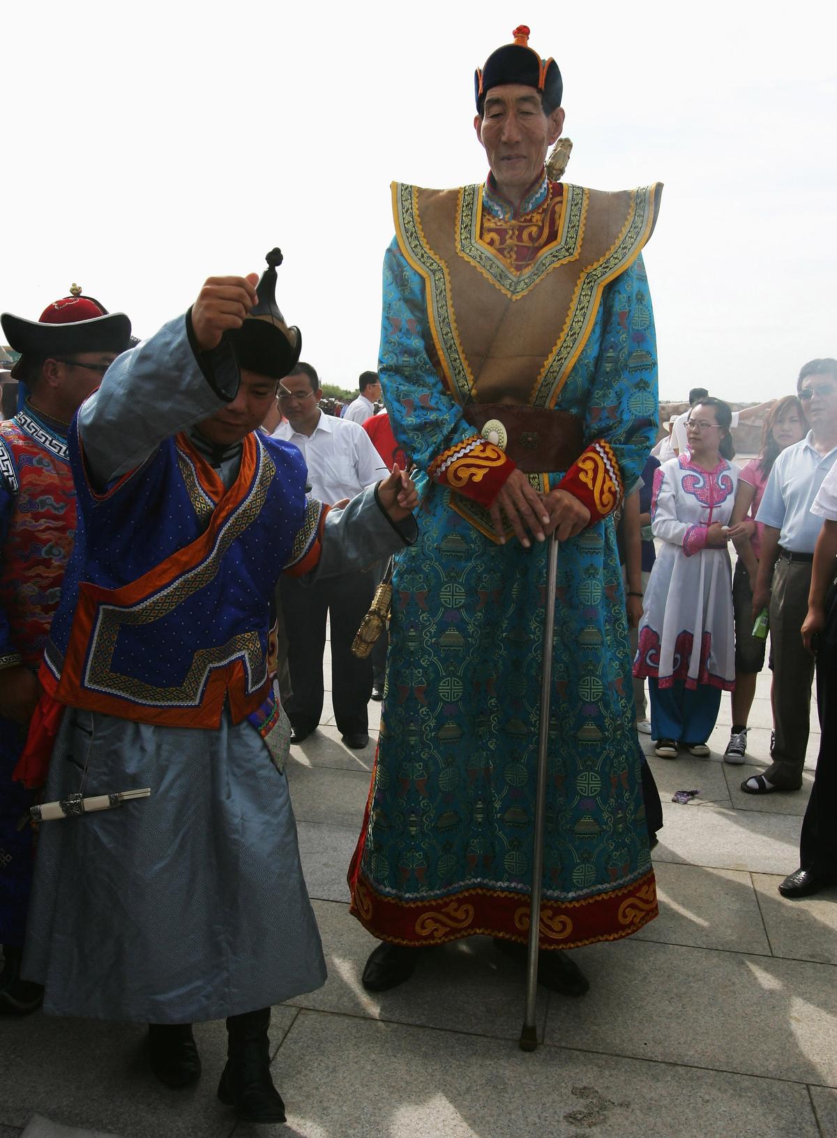 Formerly the world's tallest man, Bao Xishun (R) takes part in a traditional Mongolian wedding ceremony at the Genghis Khans Mausoleum Tourist District July 12, 2007, on the outskirt of Erdos city of Inner Mongolia Autonomous Region, China. (Guang Niu/Getty Images)