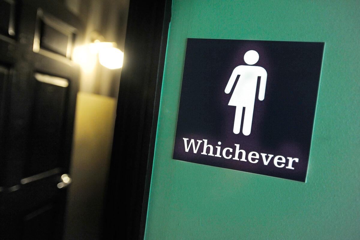 A gender-neutral sign is posted outside a bathroom at Oval Park Grill in Durham, N.C., on May 11, 2016. (Sara D. Davis/Getty Images)