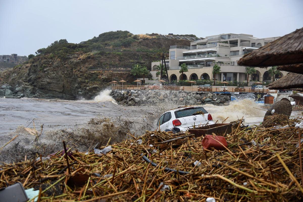 A view of an abandoned car near the sea after torrential rainfall in the village of Agia Pelagia, on the island of Crete, Greece, on Oct. 15, 2022. (Harry Nakos/AP Photo)