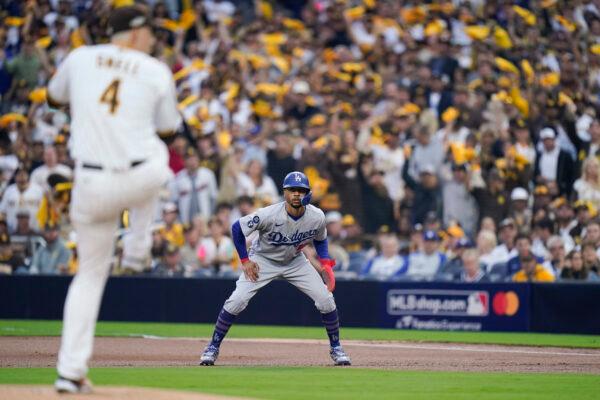 Los Angeles Dodgers' Mookie Betts, right, looks on from first base as San Diego Padres starting pitcher Blake Snell works against a Los Angeles Dodgers batter during the first inning in Game 3 of a baseball NL Division Series, in San Diego, on Oct. 14, 2022. (Jae C. Hong/AP Photo)